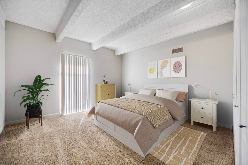 A bedroom with a bed, nightstand, and chair. at The Lex At Lowry, Denver, 80224