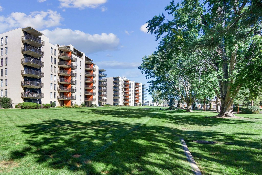 A grassy area in front of apartment buildings. at The Lex At Lowry, Denver