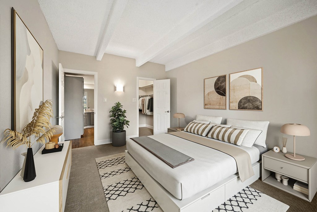 A bedroom with a large bed and a painting on the wall. at The Lex At Lowry, Denver, 80224