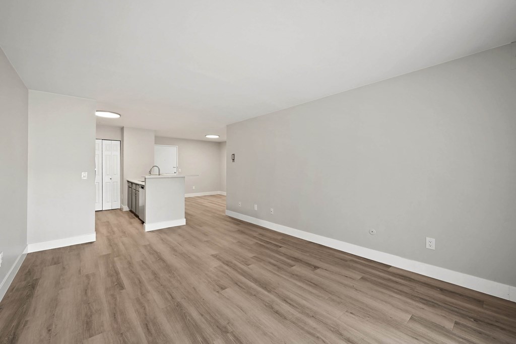 A room with wooden flooring and white walls. at The Lex At Lowry, Denver