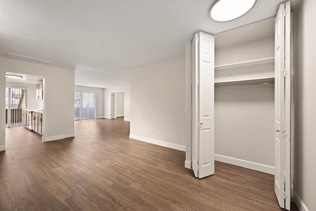 A large, empty room with wooden floors and white walls. at The Lex At Lowry, Denver, Colorado