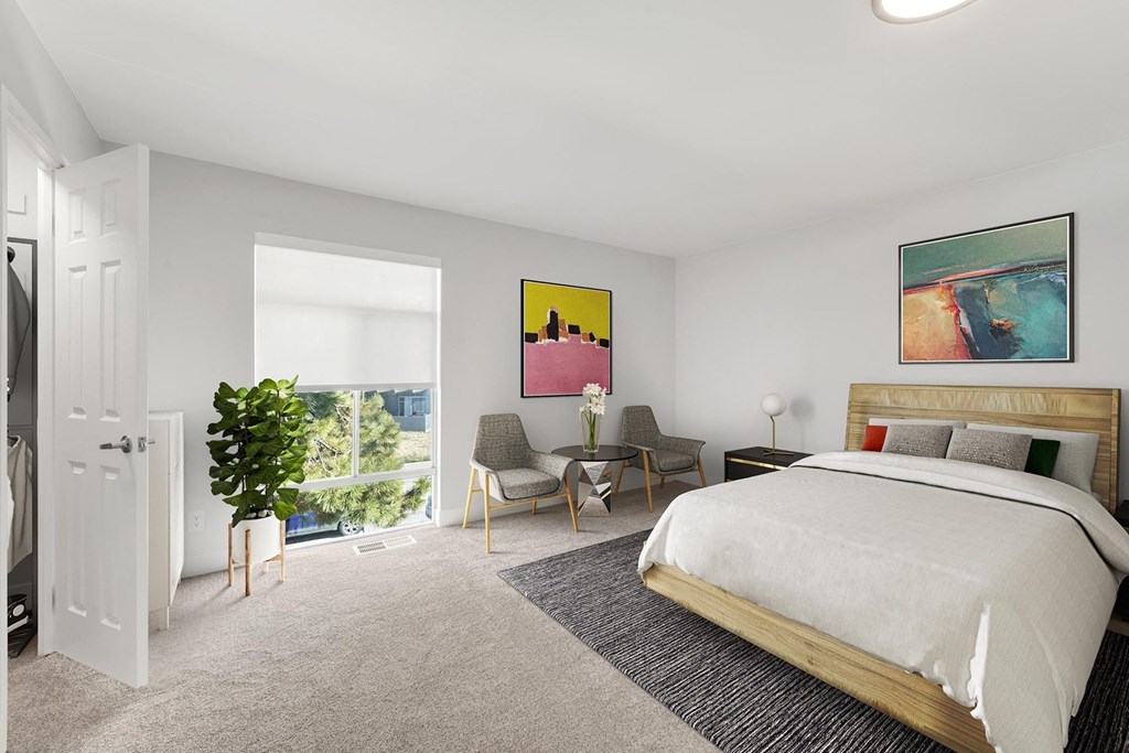 A bedroom with a large bed and a painting on the wall. at The Lex At Lowry, Denver, Colorado