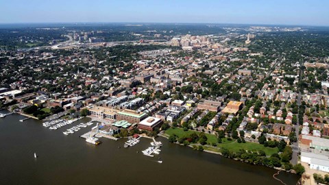A cityscape with a large body of water in the foreground.