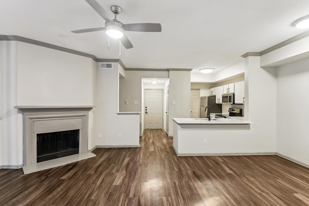 A living room with a fireplace and a ceiling fan. A living room with a fireplace and a ceiling fan.at Onyx183, Austin, TX 78729