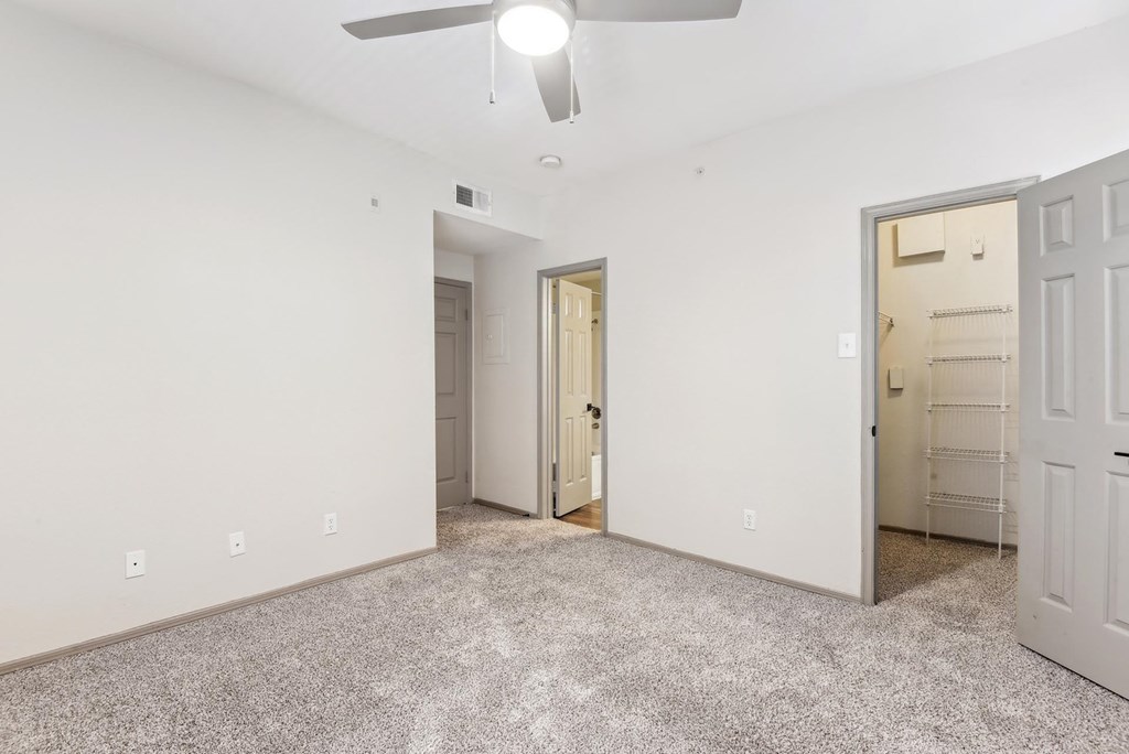 A room with a ceiling fan and two doors. A room with a ceiling fan and two doors.at Onyx183, Austin, TX