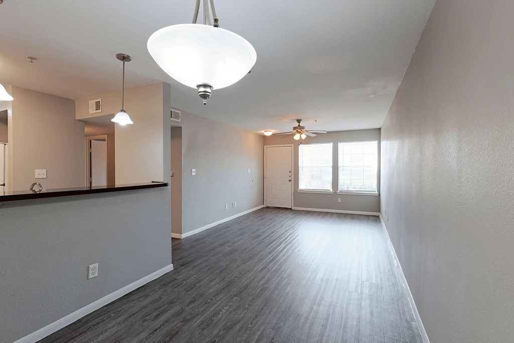 A spacious room with a grey floor and white walls.