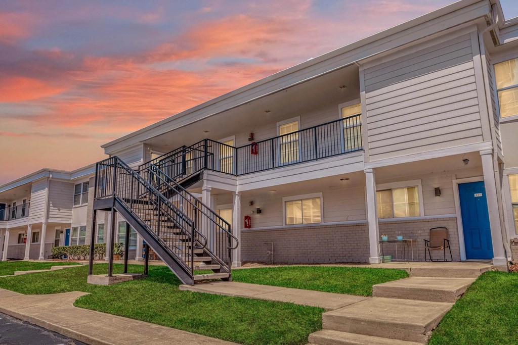 A modern apartment building with a staircase leading to the second floor.