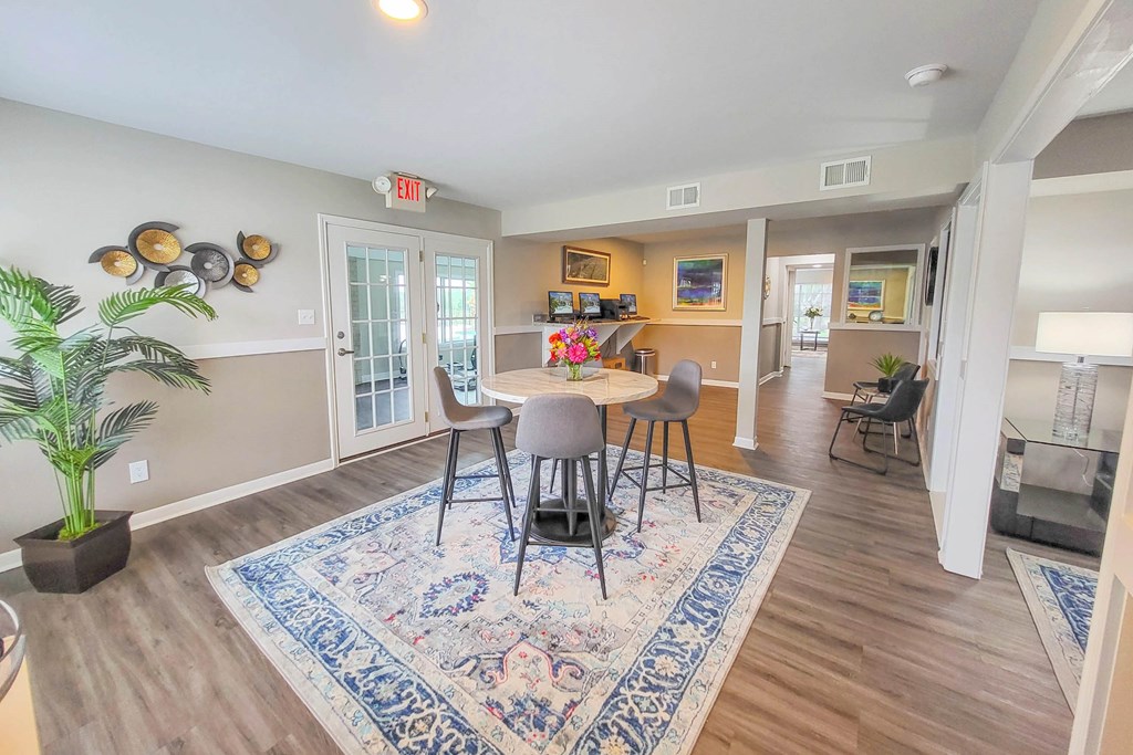 A dining room with a table and chairs.