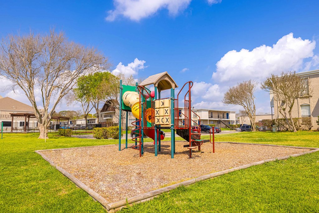 A playground with a slide and a swing set.