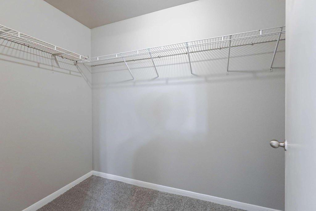 Empty room with white walls and a door on the right.