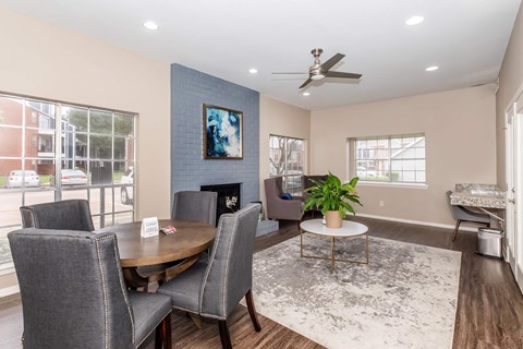 A modern dining room with a wooden table and grey chairs.