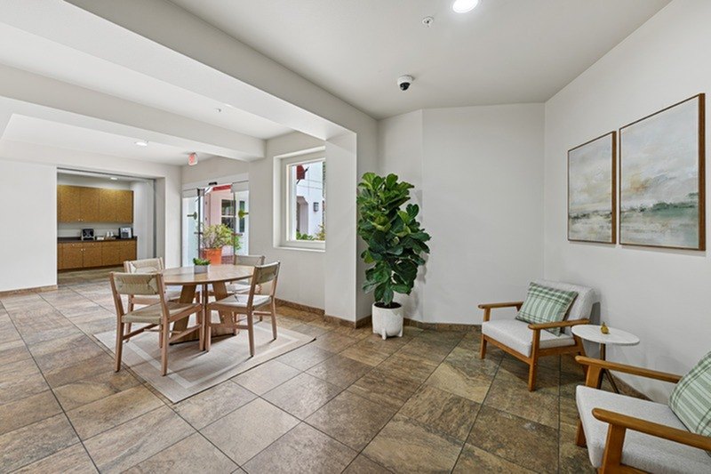 A living room with a dining table and chairs.