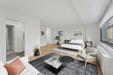 A modern bedroom with a large bed and a chair.