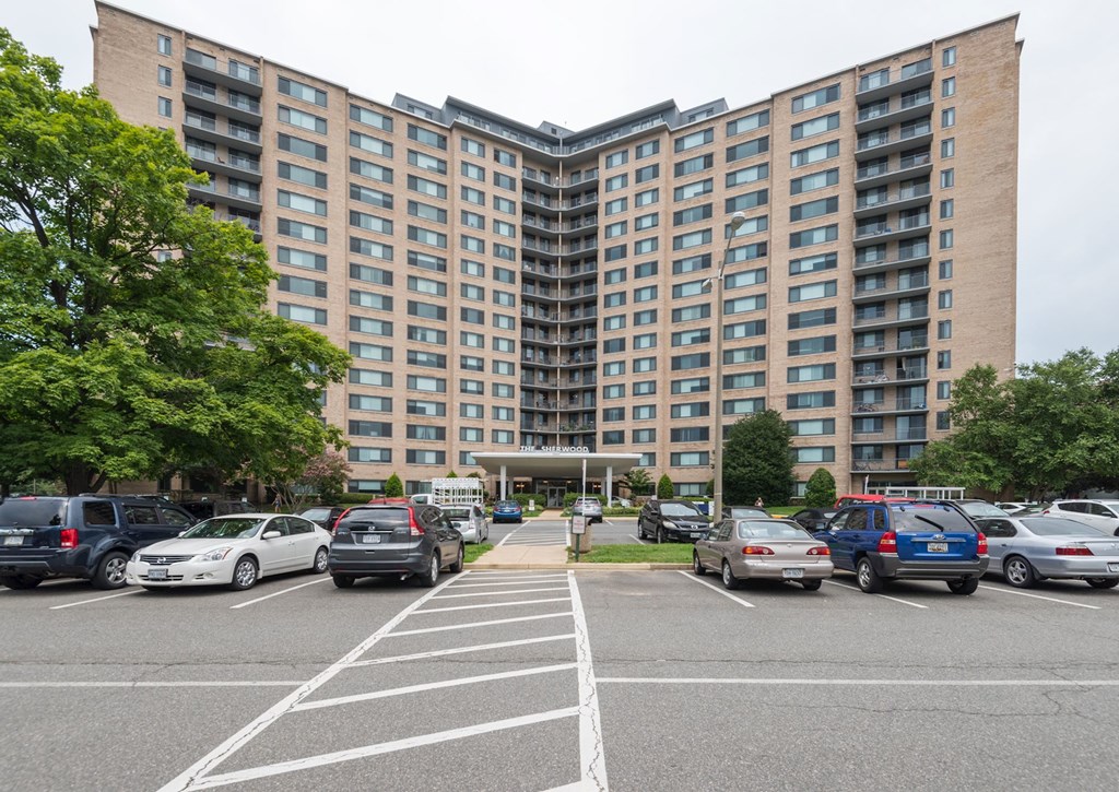 A parking lot in front of a large apartment building.at Sherwood at Southern Towers, Alexandria, VA 22311