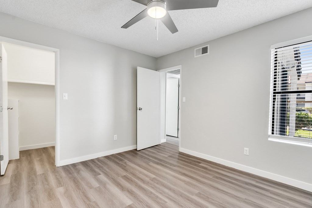 A room with a ceiling fan and a window with blinds.at Solara, Phoenix