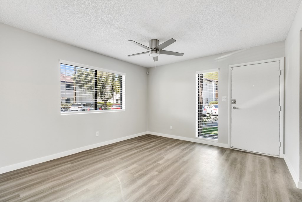 A room with a ceiling fan and a door leading to a balcony.at Solara, Phoenix, AZ 85033