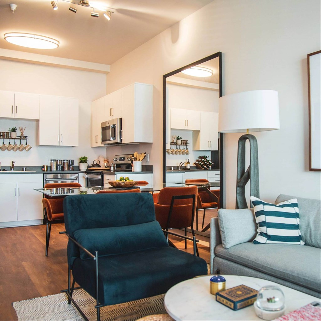 Living room with kitchen view at Sora Apartments, Inglewood, CA