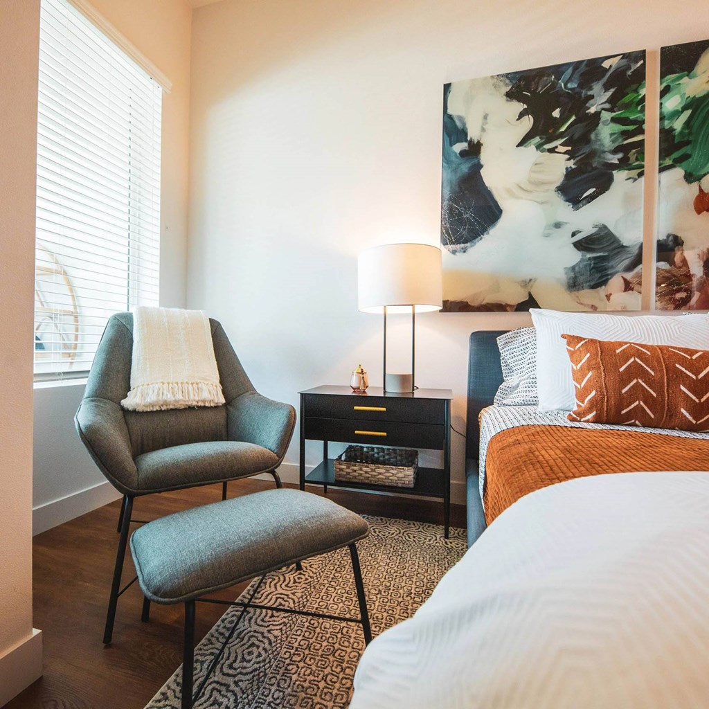 Bedroom with a bed and a comfortable chair at Sora Apartments, Inglewood, 90302