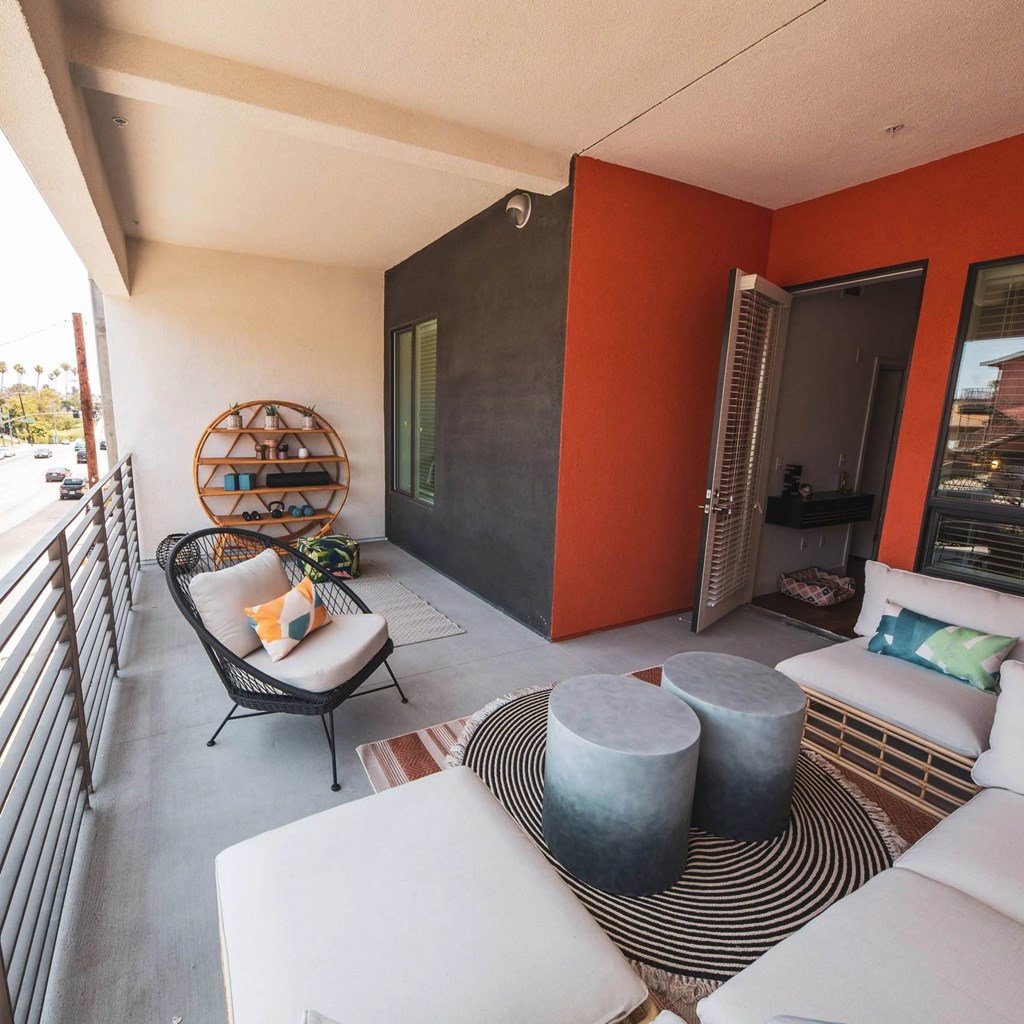 Patio with chairs and couch at Sora Apartments, Inglewood, CA