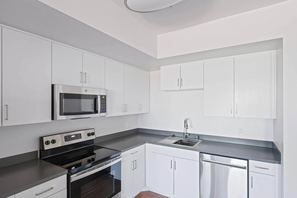 Kitchen with sink and white cabinets at Sora Apartments, Inglewood, CA, 90302