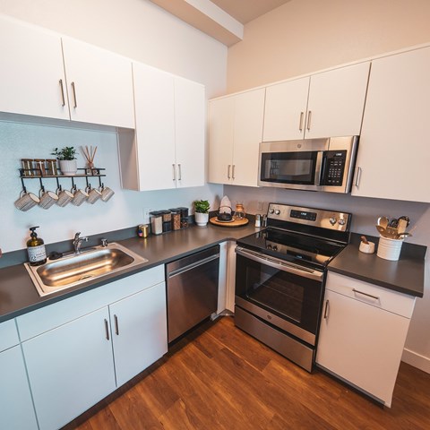 Kitchen with stove top oven at Sora Apartments, California