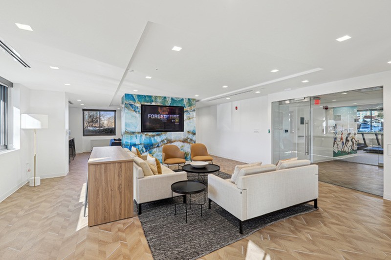 A living room with a white couch and a wooden table.
