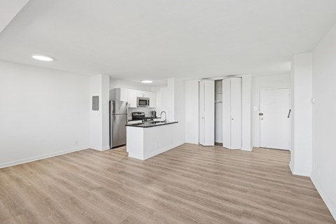A kitchen with white cabinets and a wooden floor. at Stratford at Southern Towers, Alexandria
