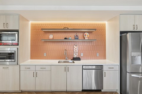 A kitchen with a sink and a refrigerator.