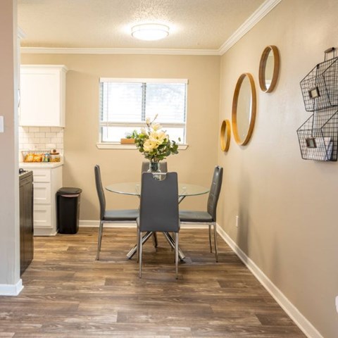 A dining room with a table and chairs.