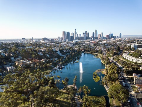 A cityscape with a fountain in the foreground and a skyline in the background.at 1915 Park, Los Angeles, CA 90026