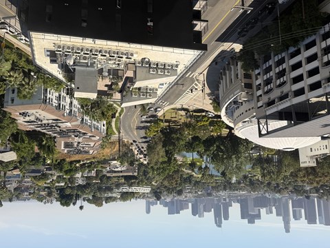 A cityscape reflected in a body of water.