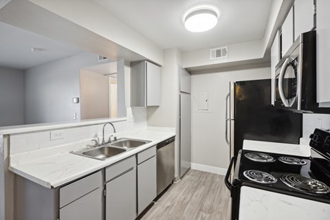A modern kitchen with a black stove top oven.