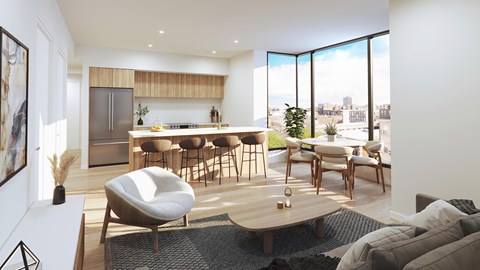 A modern living room with a kitchen in the background and a large window.