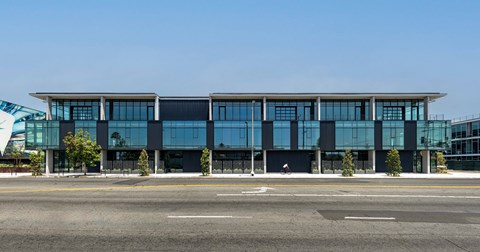 A modern building with large windows and a flat roof.