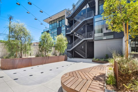 A modern building with a staircase and a bench in front.