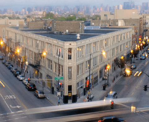 A street view of a city with cars and buildings.