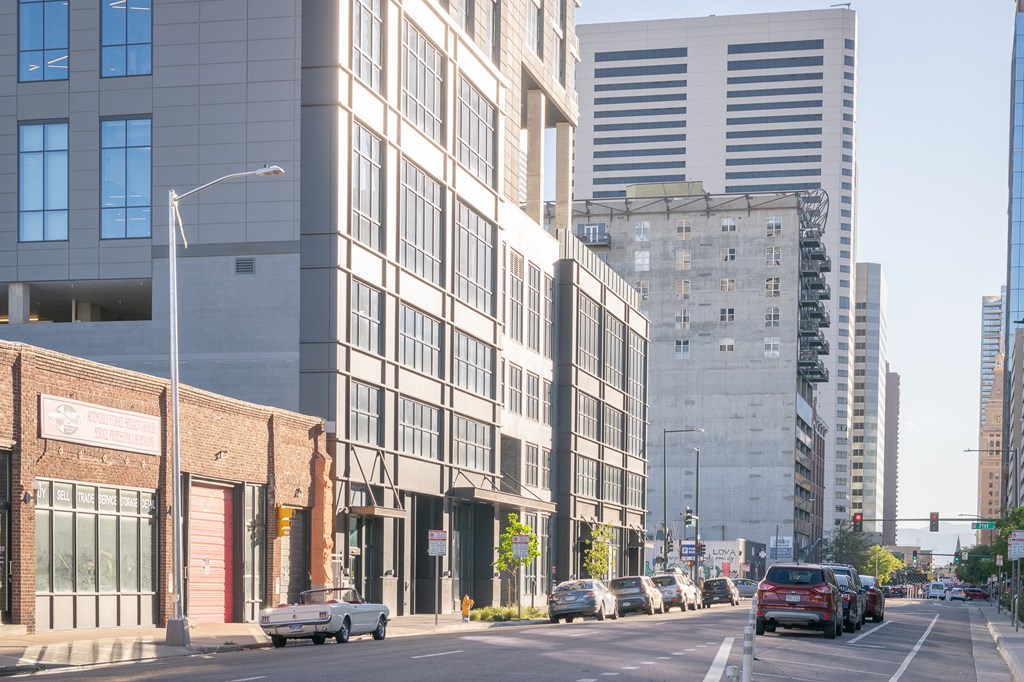City street with cars and buildings at Velaris Living Apartments, Denver, CO