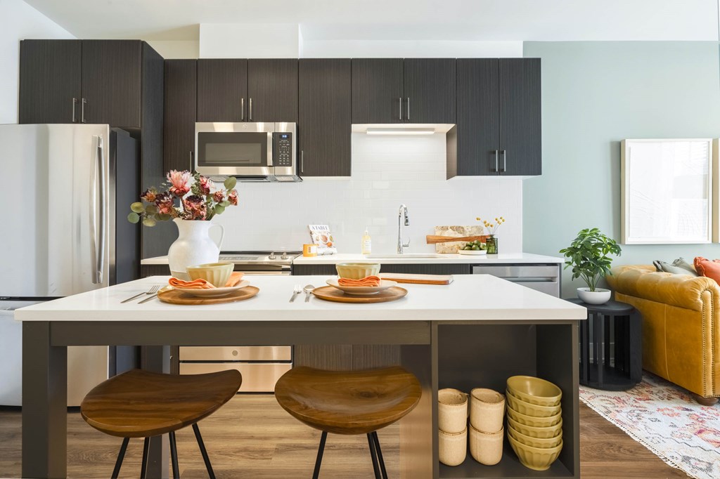 A modern kitchen with a dining table set for two. A modern kitchen with a dining table set for two.at The Vale at the Parks, Washington, DC 20012