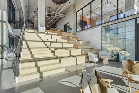 A modern interior with a staircase and a glass wall.