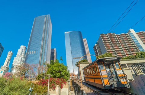 A cityscape with a tram in the foreground.