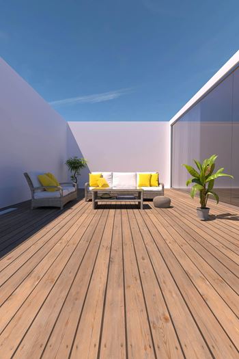 A wooden deck with two chairs and a table at Coro Apartments, California