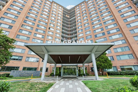 The Graham apartment building has a covered walkway leading to the entrance.