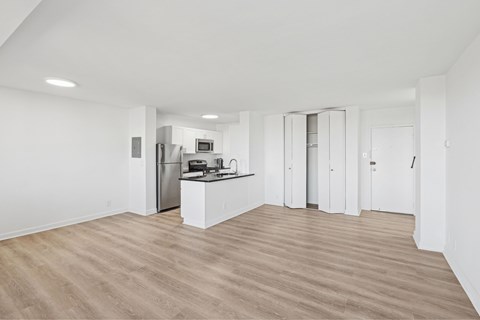 A kitchen area with a refrigerator, microwave, and oven.