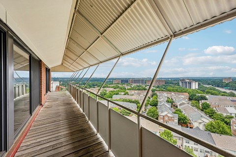 A balcony with a view of a cityscape.
