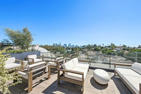 A patio with white furniture and a view of the city at 1915 Park, Los Angeles, CA 90026
