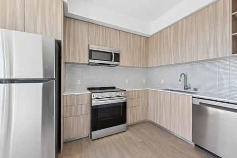 A modern kitchen with a stainless steel refrigerator, oven, and microwave at 1915 Park, Los Angeles, CA 90026
