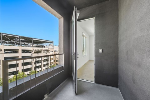 A balcony with a view of a parking lot and a building at 1915 Park, Los Angeles, CA 90026