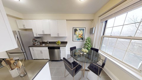 a kitchen and dining area with a glass table and chairs