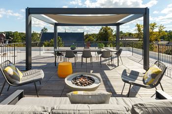 Sun-filled sky deck with pergola and fire pit
