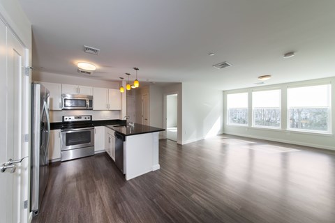 A modern kitchen with stainless steel appliances and a large island.